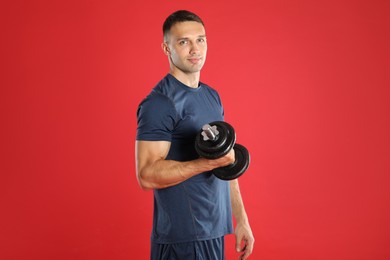 Photo of Man exercising with barbell on red background