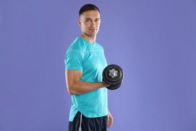 Photo of Man exercising with barbell on violet background