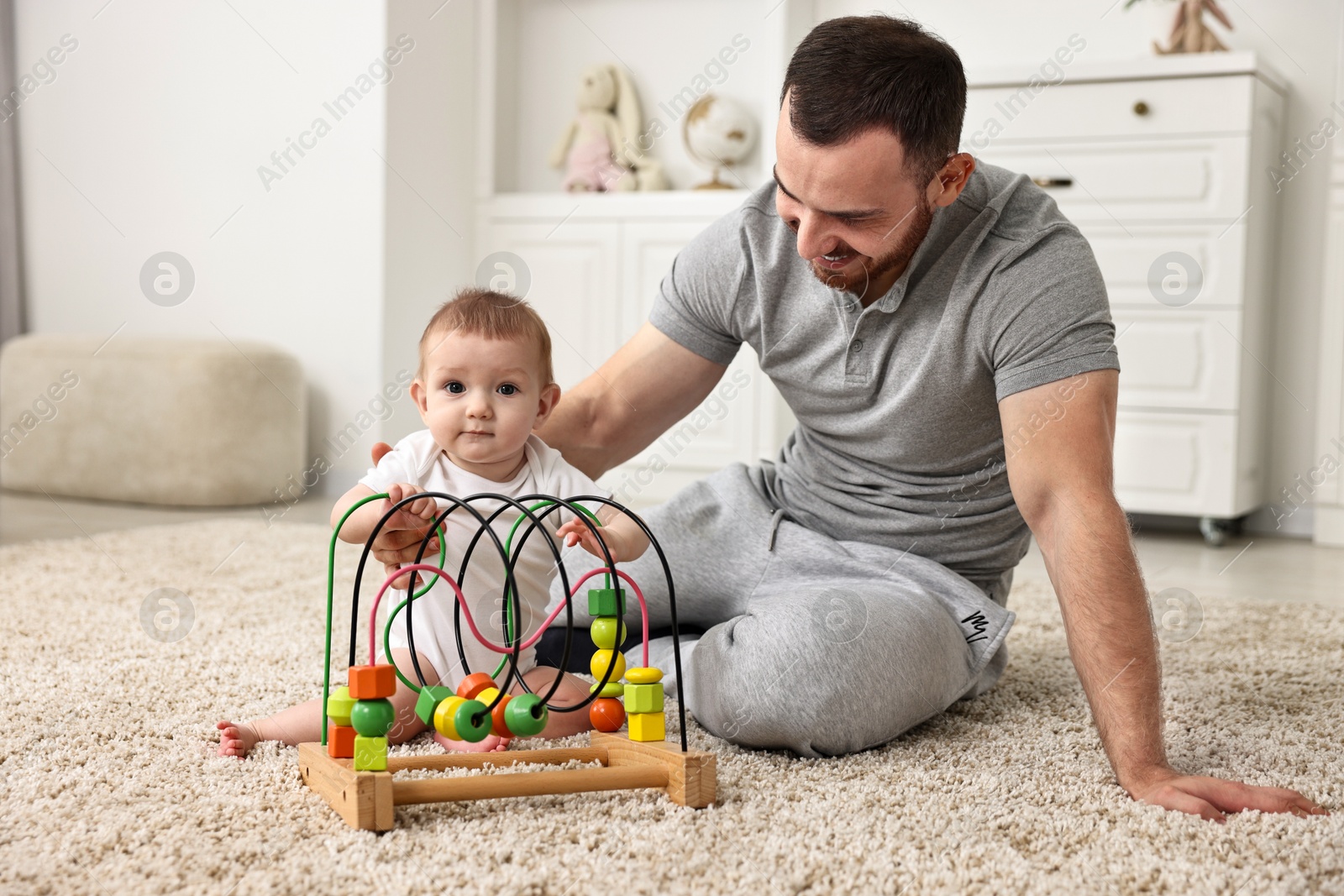 Photo of Dad playing with his cute baby at home