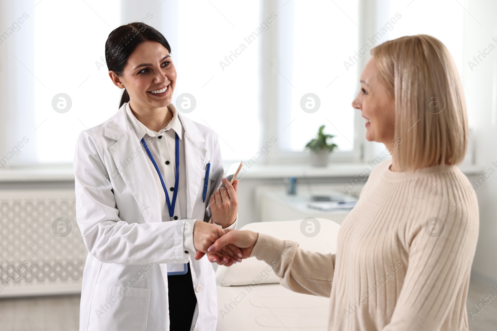 Photo of Doctor and patient shaking hands in clinic