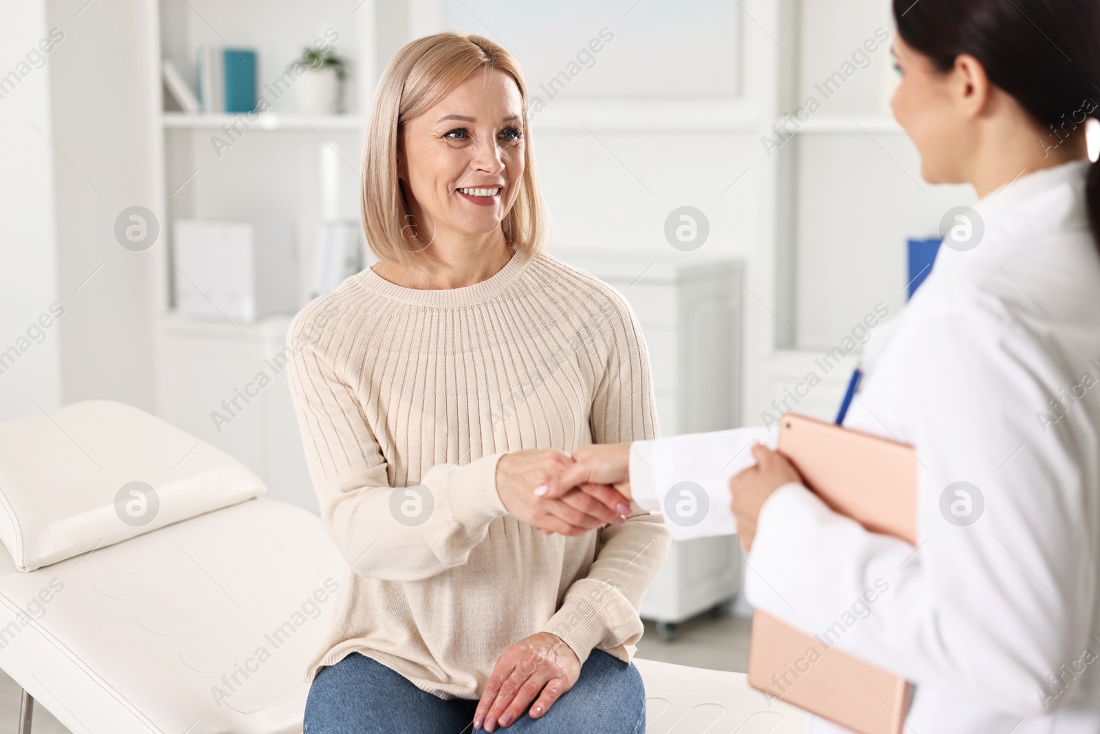 Photo of Doctor and patient shaking hands in clinic