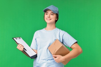 Photo of Girl in uniform with parcel and clipboard on green background. Work for teenagers