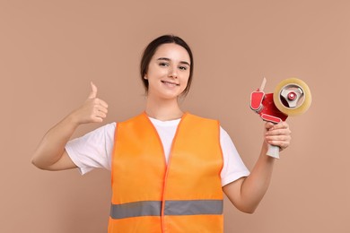 Photo of Girl in uniform with adhesive tape showing thumbs up on pale brown background. Work for teenagers