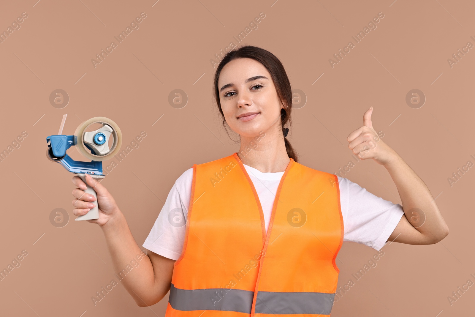 Photo of Girl in uniform with adhesive tape showing thumbs up on pale brown background. Work for teenagers