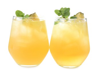 Photo of Tasty pineapple cocktail with mint in glasses isolated on white