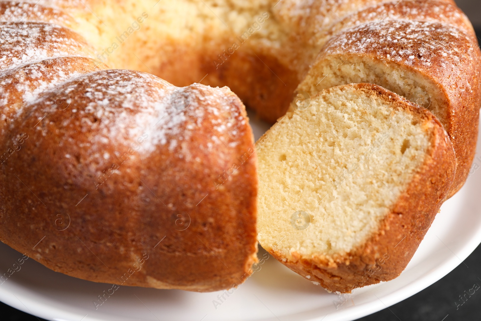 Photo of Freshly baked sponge cake on stand, closeup