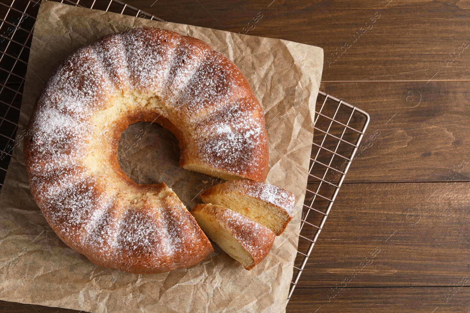 Photo of Freshly baked sponge cake on wooden table, top view