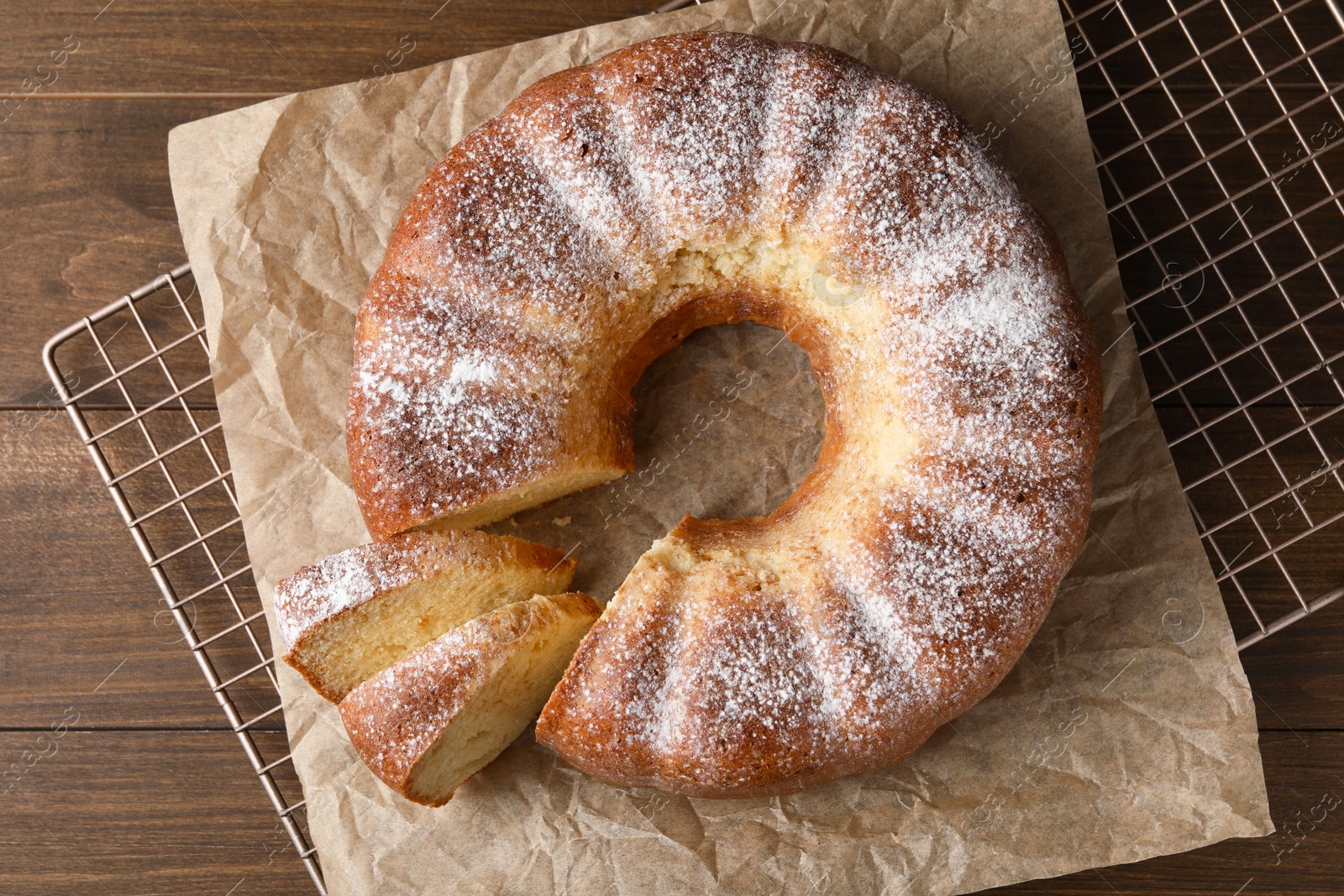 Photo of Freshly baked sponge cake on wooden table, top view