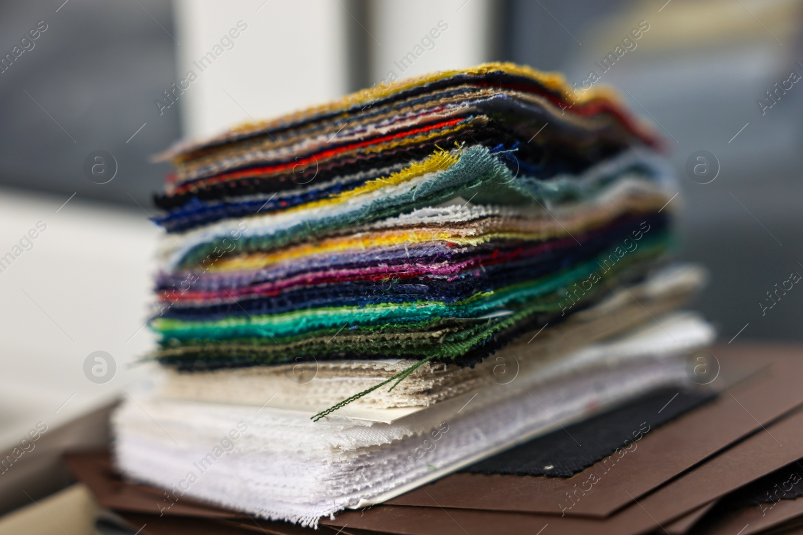 Photo of Many different types of fabric in professional atelier, closeup