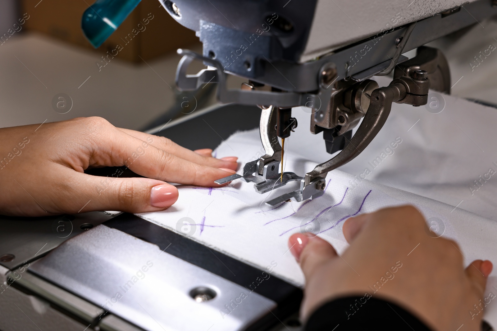 Photo of Woman working with sewing machine in professional workshop, closeup