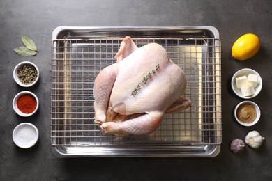 Photo of Raw turkey and spices on grey table, flat lay