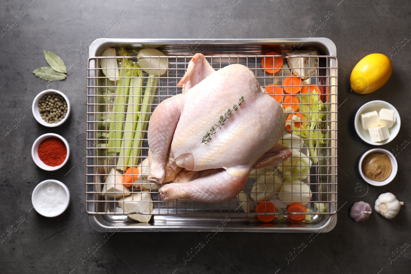 Photo of Raw turkey with different vegetables and spices on grey table, flat lay