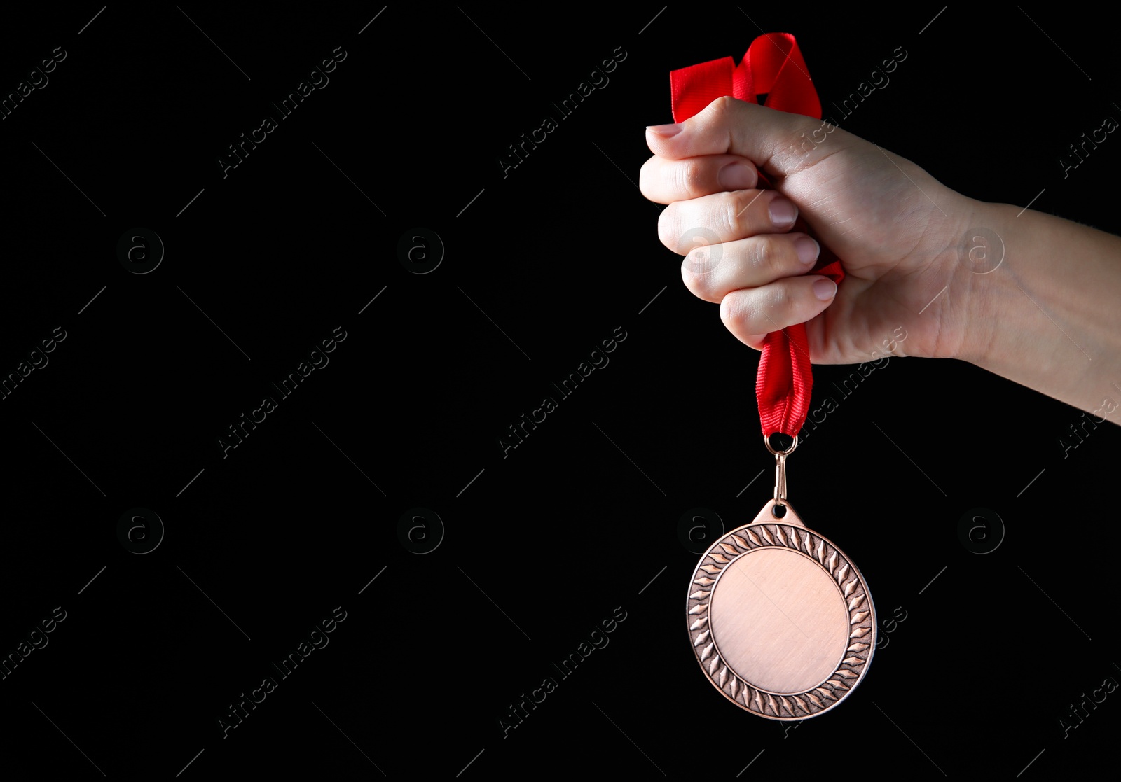 Photo of Woman with bronze medal on black background, closeup. Space for text