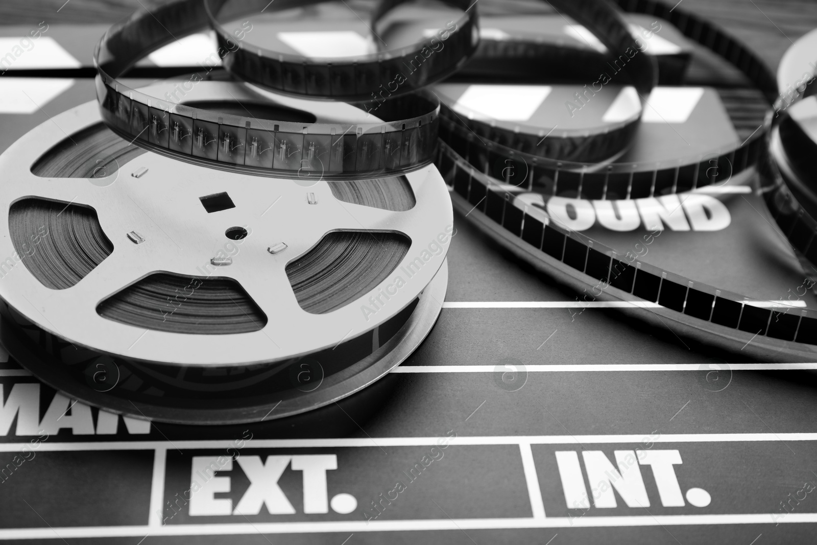 Photo of Movie clapper and film reel on table, closeup