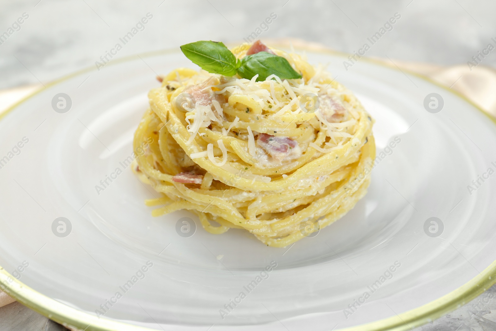 Photo of Plate with delicious pasta Carbonara on table, closeup