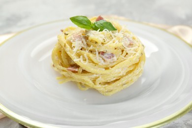 Photo of Plate with delicious pasta Carbonara on table, closeup