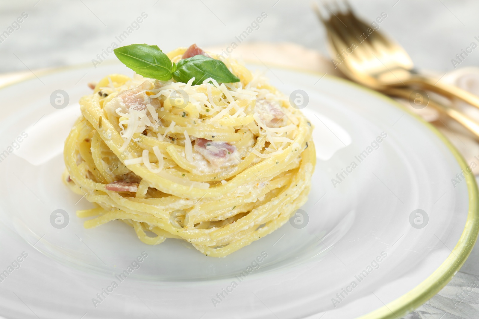 Photo of Plate with delicious pasta Carbonara on table, closeup