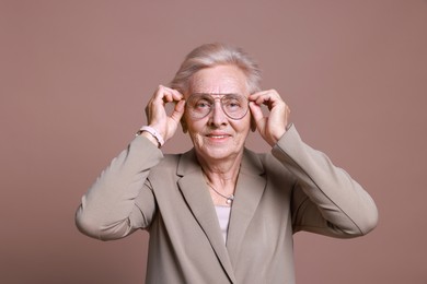 Photo of Portrait of senior woman on color background