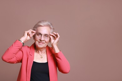 Photo of Portrait of senior woman on color background. Space for text