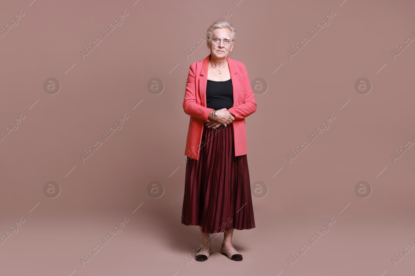 Photo of Full length portrait of senior woman on color background