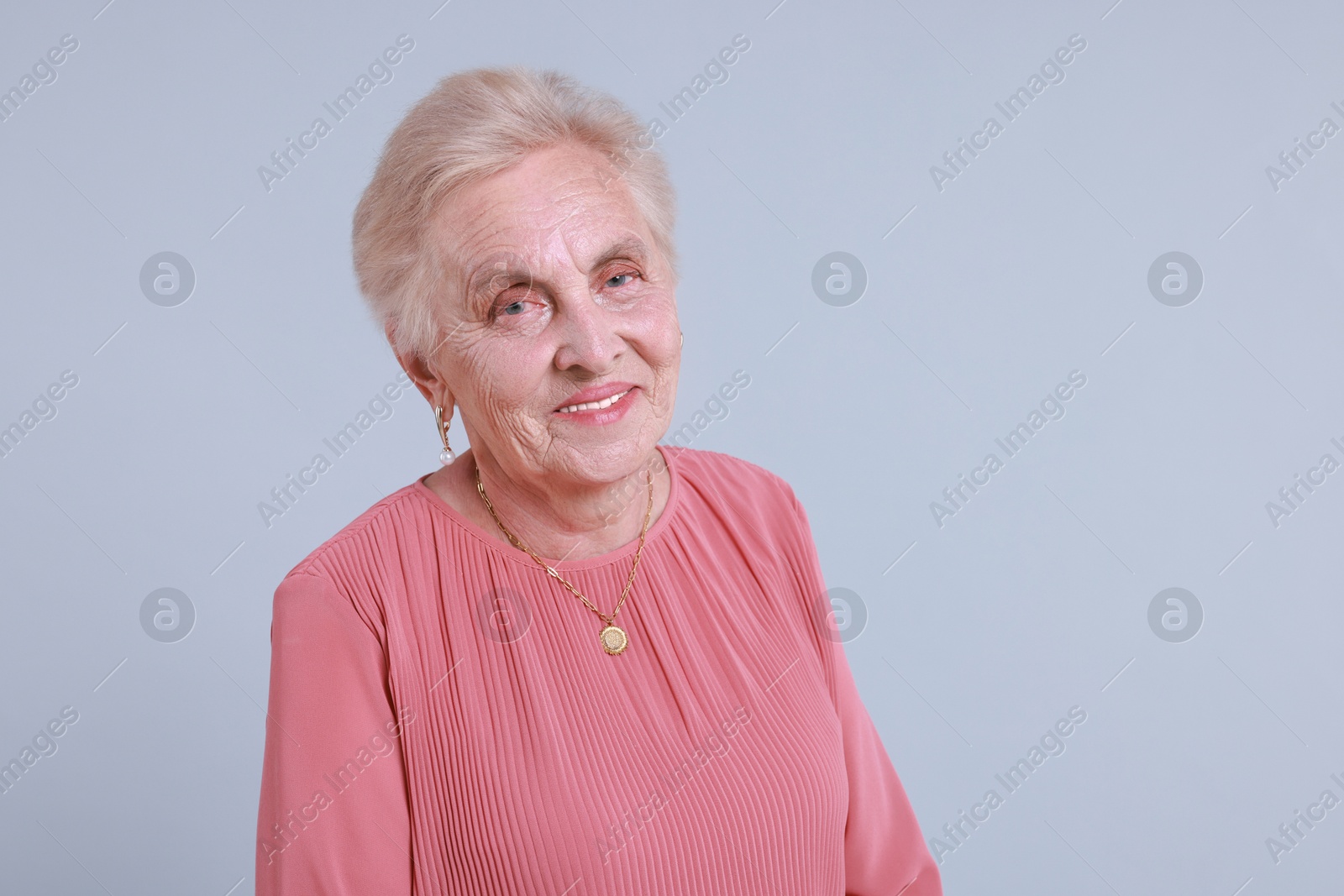 Photo of Portrait of senior woman on light background. Space for text