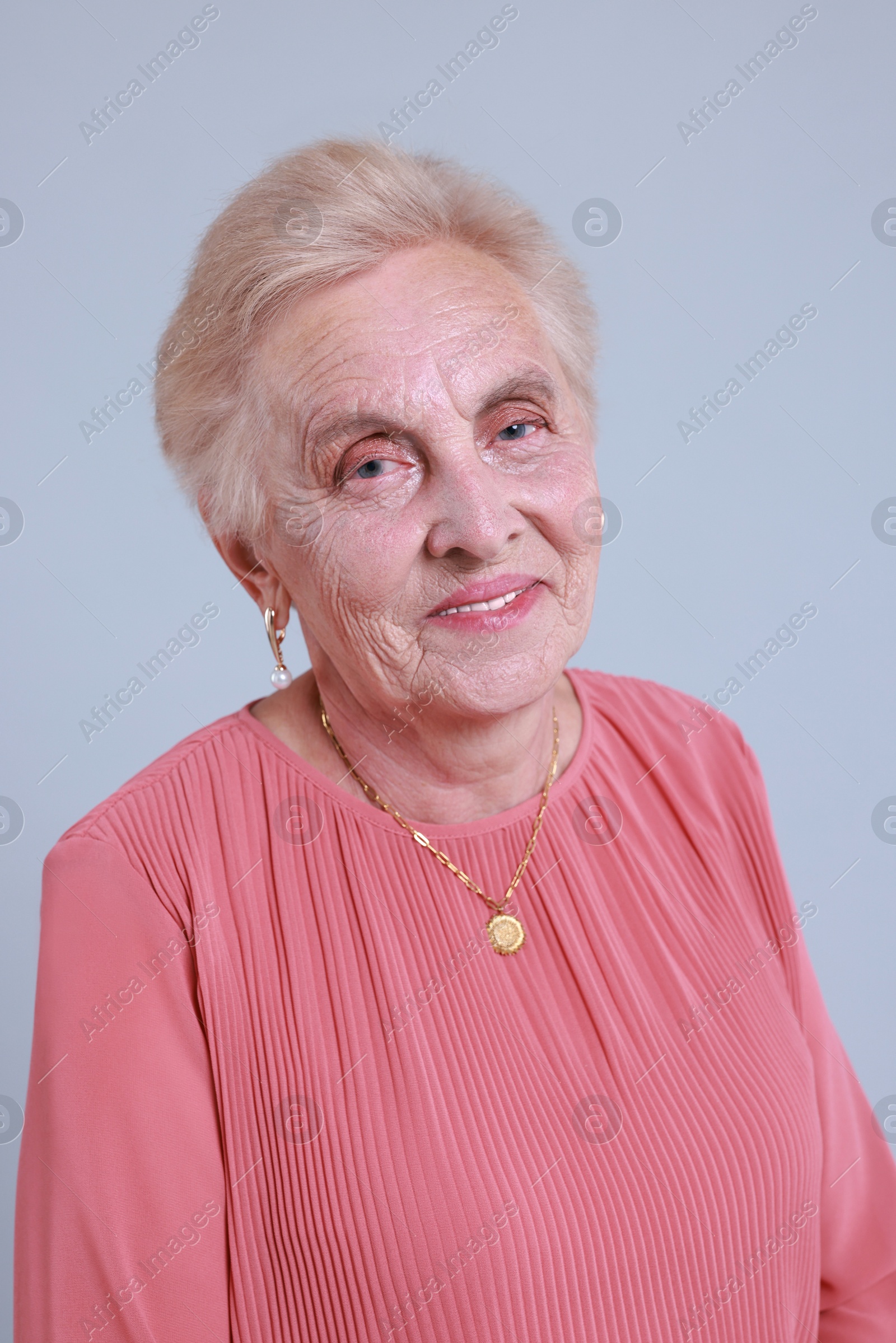 Photo of Portrait of senior woman on light background