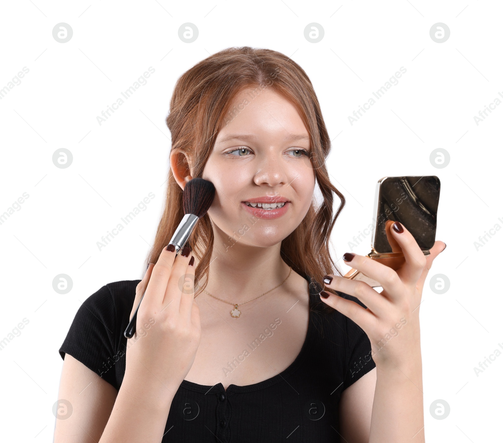 Photo of Smiling teenage girl applying blusher with makeup brush on white background