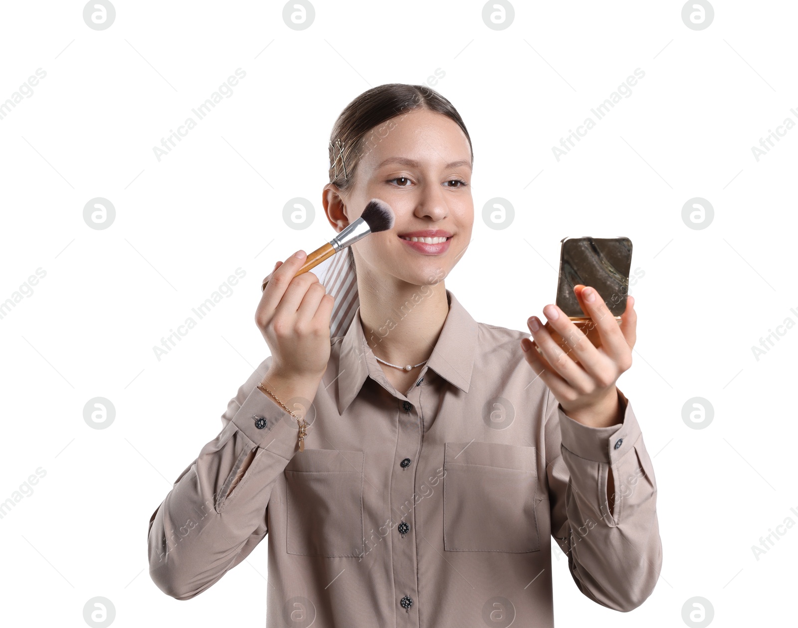 Photo of Smiling teenage girl applying blusher with makeup brush on white background