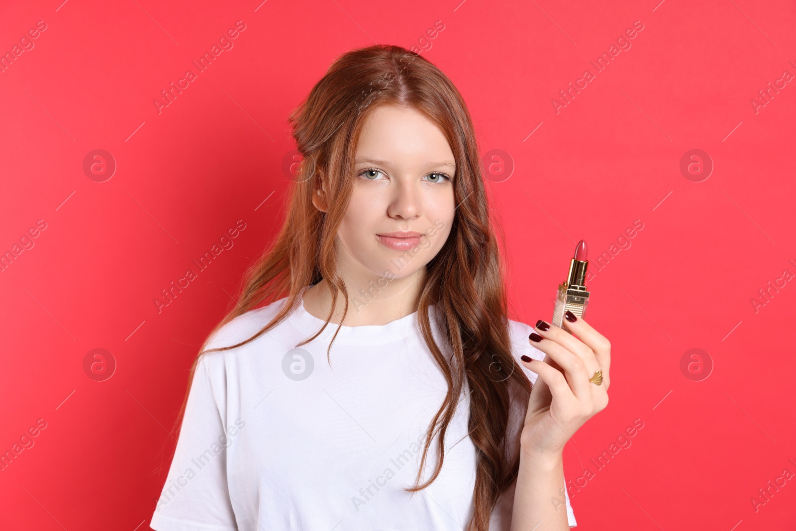 Photo of Teenage girl with lipstick on red background