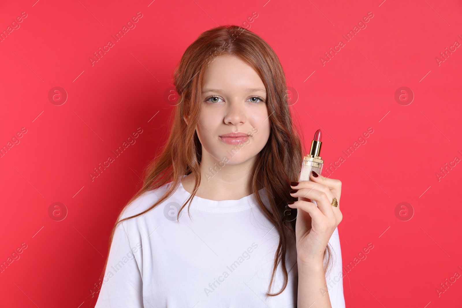 Photo of Teenage girl with lipstick on red background