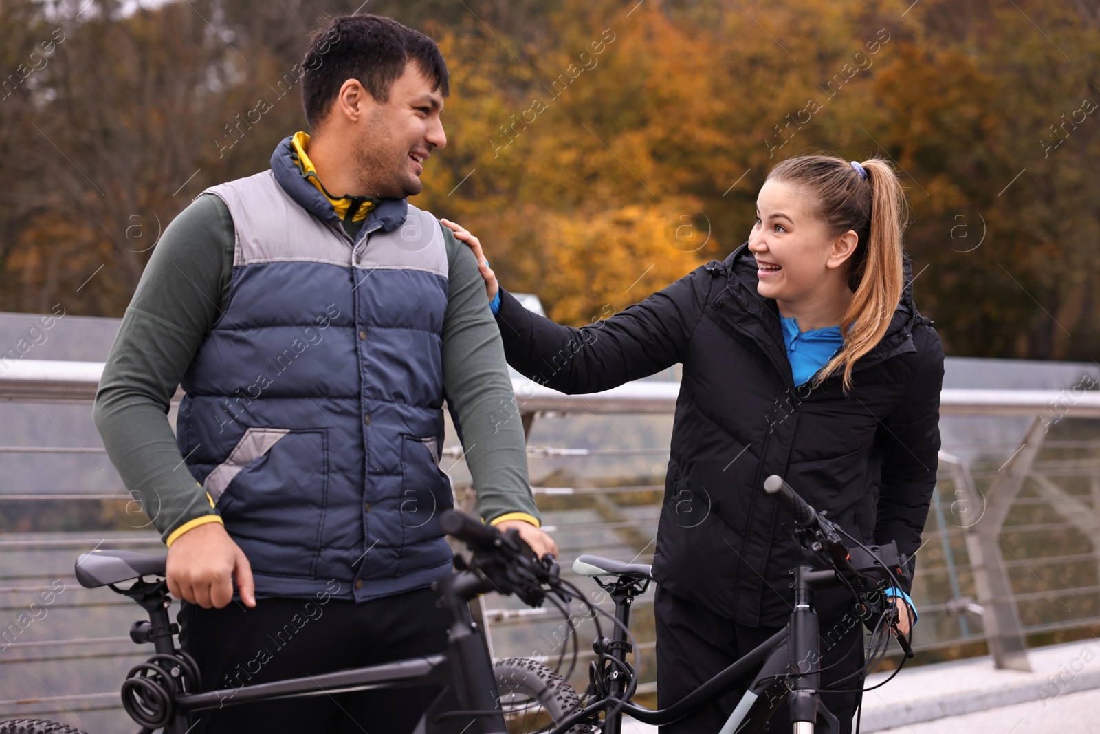 Photo of Beautiful happy couple with bicycles spending time together outdoors