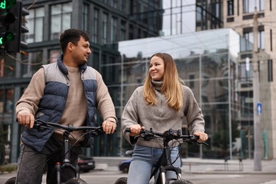 Photo of Beautiful happy couple with bicycles spending time together outdoors