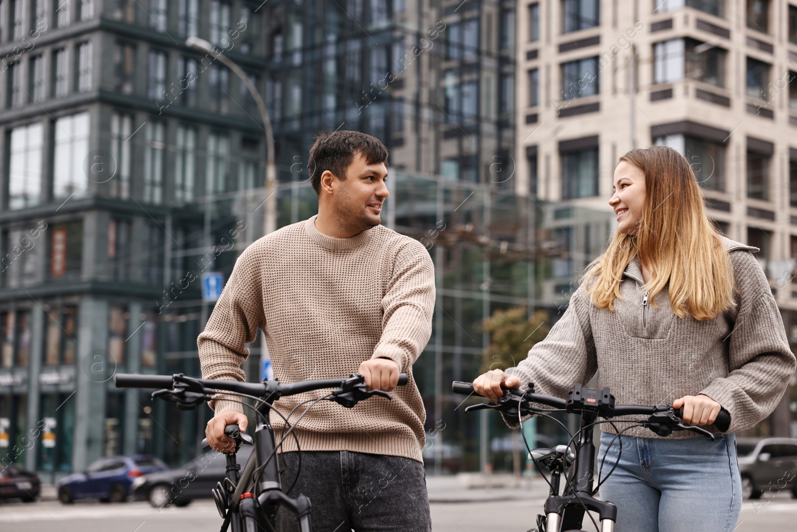 Photo of Beautiful happy couple with bicycles spending time together outdoors