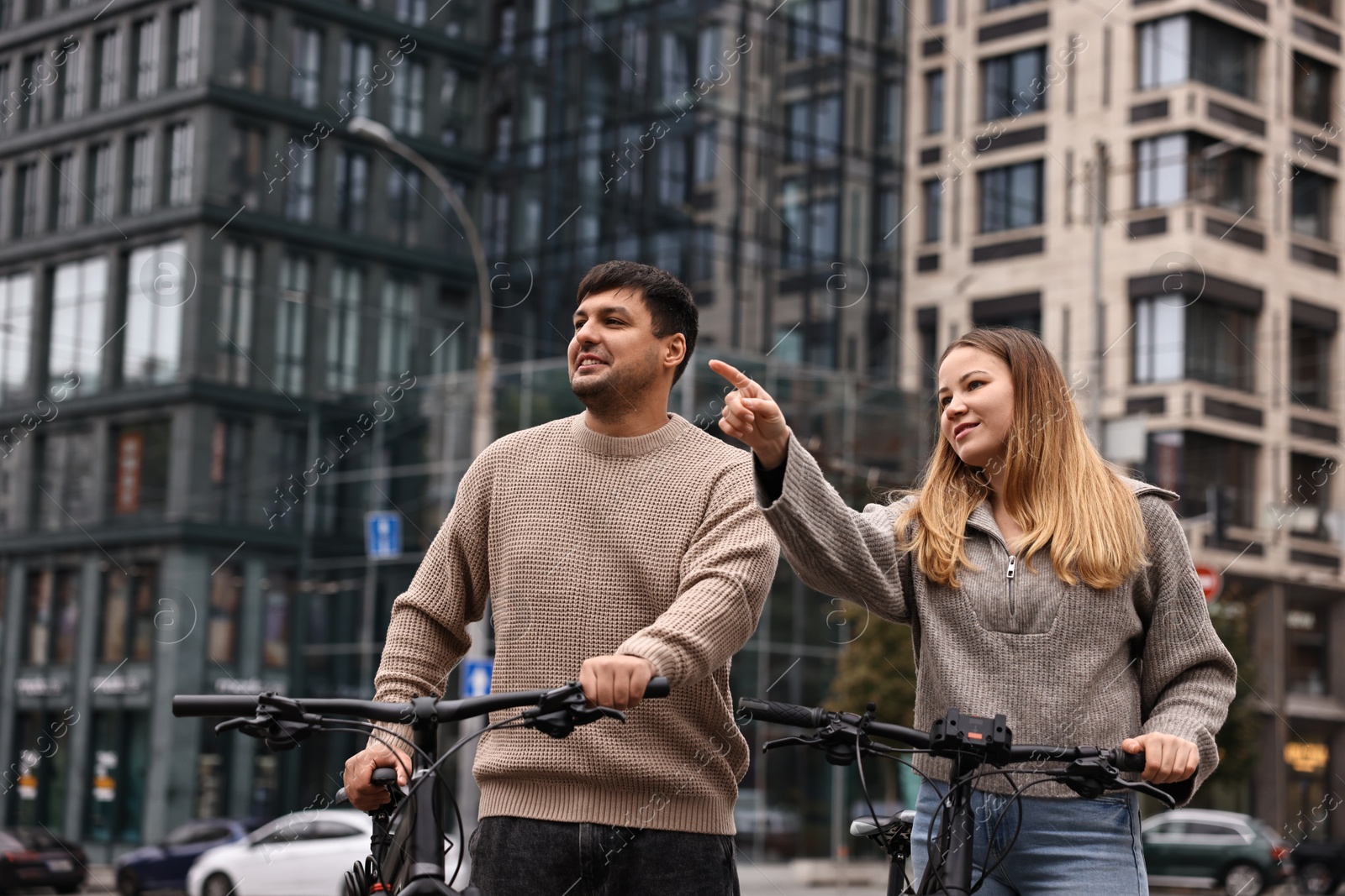 Photo of Beautiful happy couple with bicycles spending time together outdoors