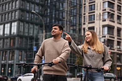 Photo of Beautiful happy couple with bicycles spending time together outdoors