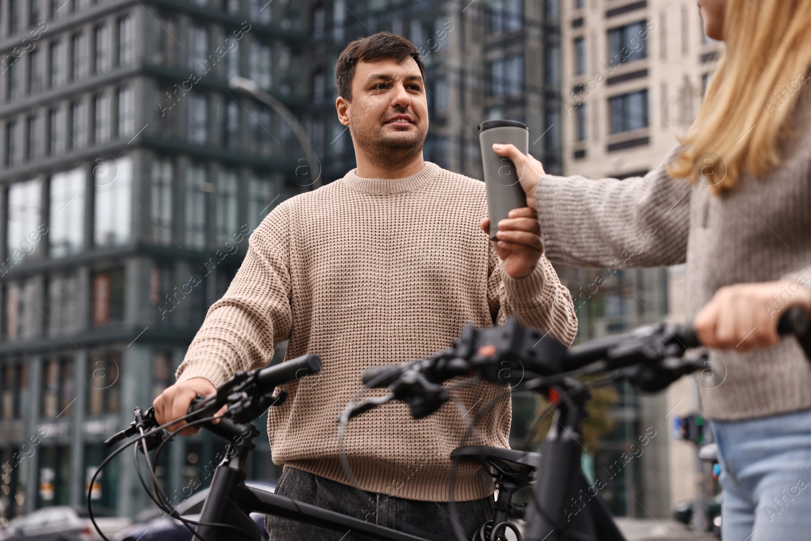 Photo of Beautiful happy couple with bicycles spending time together outdoors