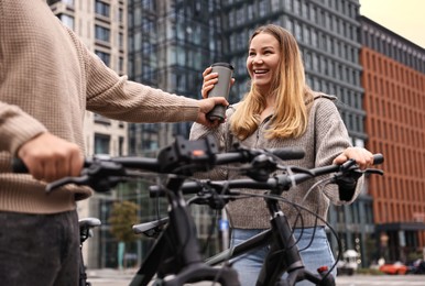 Photo of Beautiful happy couple with bicycles spending time together outdoors