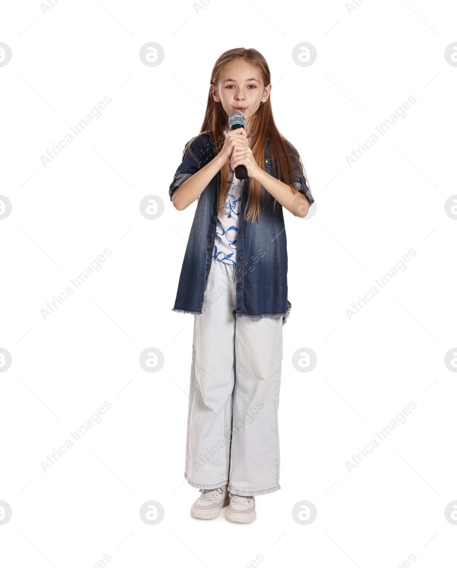 Photo of Little girl with microphone singing on white background