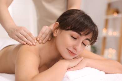 Young woman receiving massage in spa salon