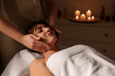 Photo of Young woman receiving massage in spa salon