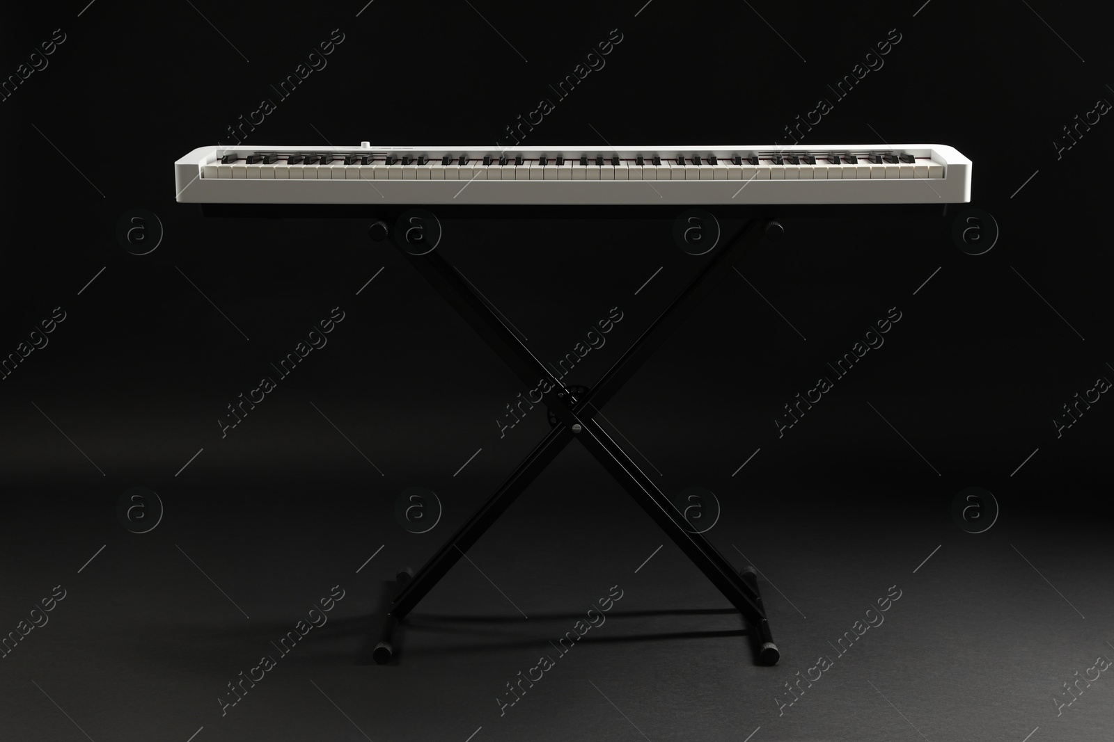 Photo of Synthesizer on black background. Electronic musical instrument