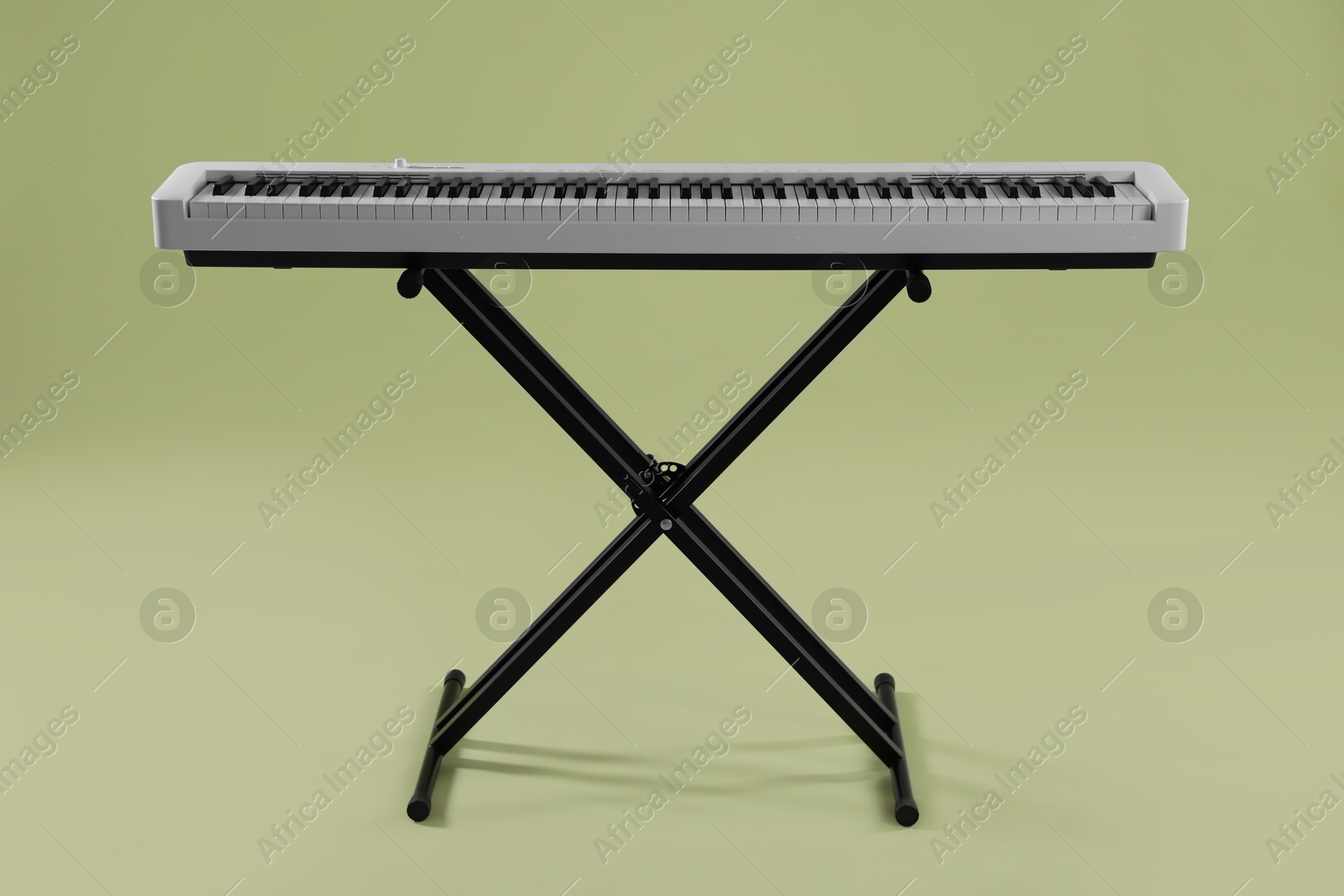 Photo of Synthesizer on green background. Electronic musical instrument