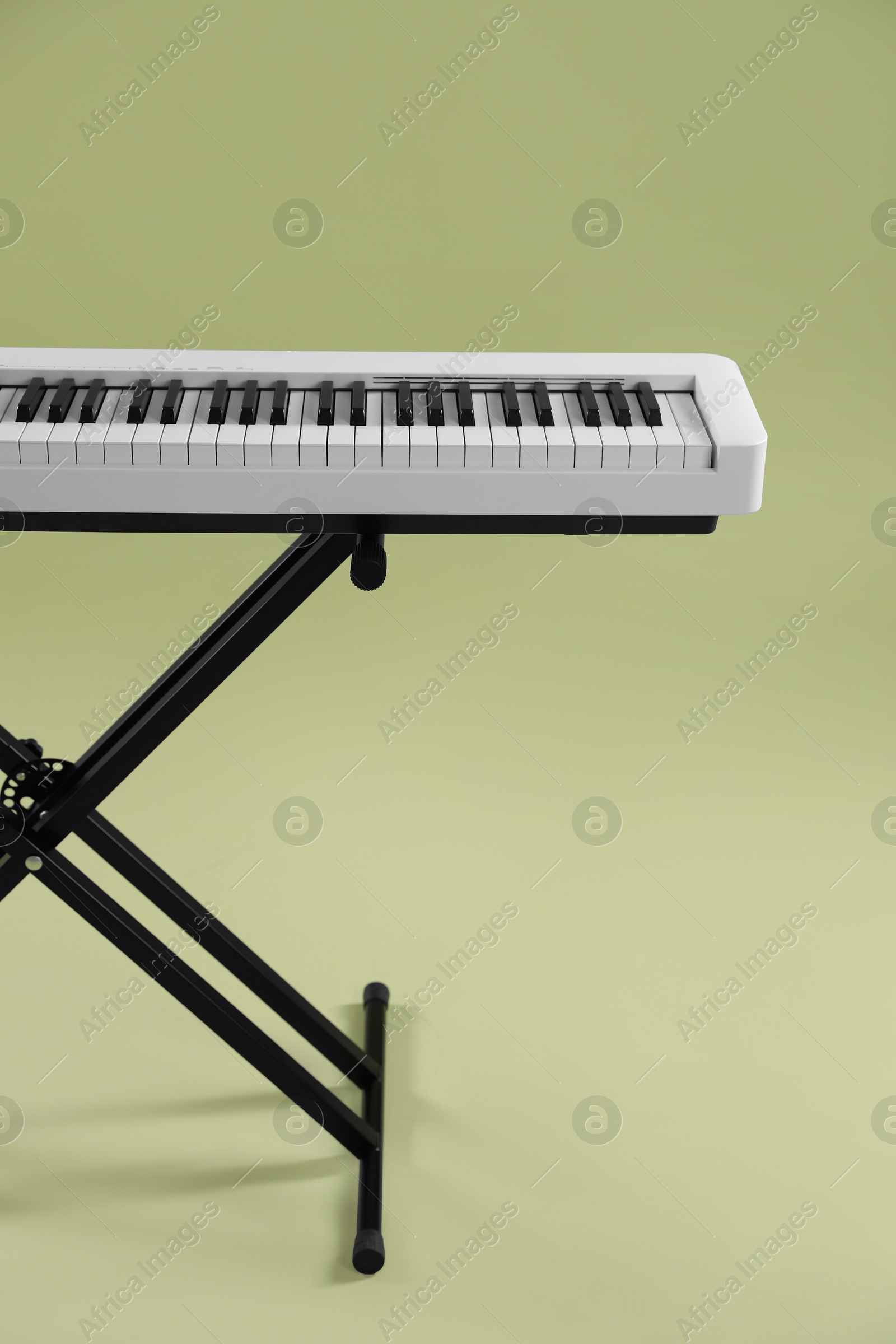 Photo of Synthesizer on green background. Electronic musical instrument