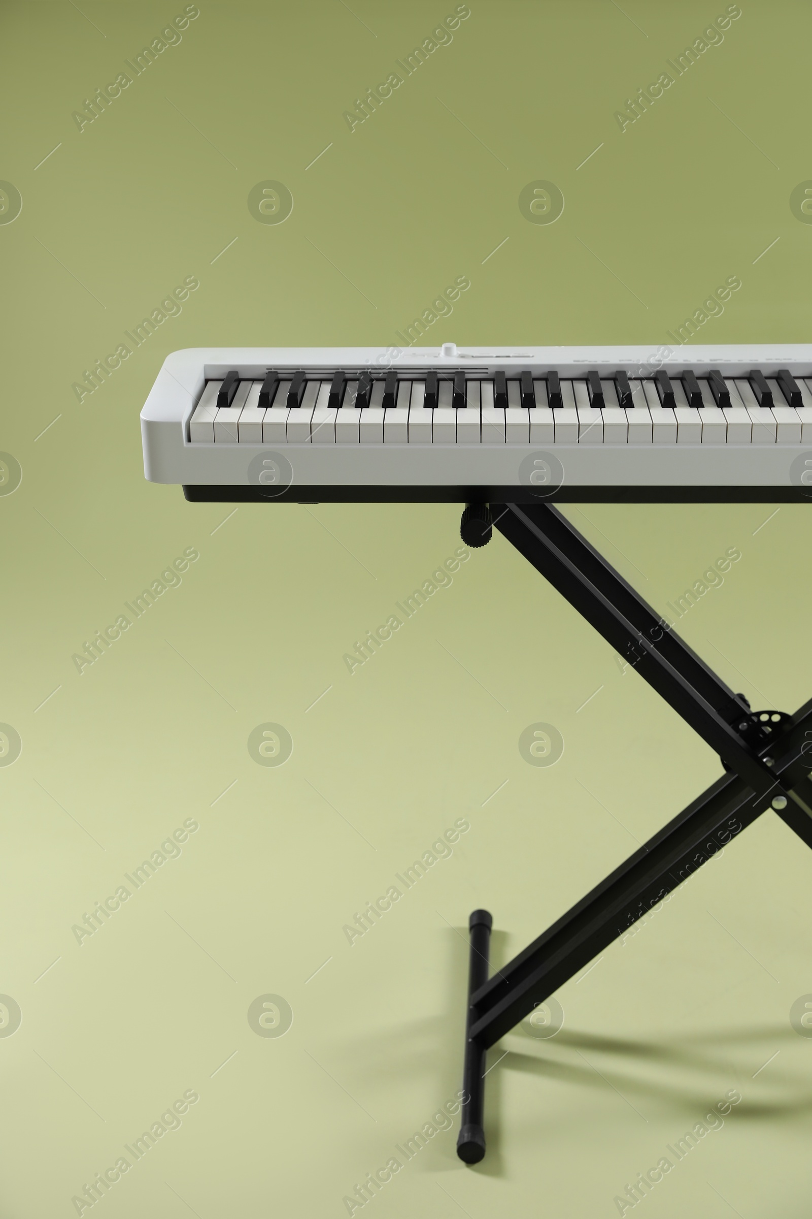 Photo of Synthesizer on green background. Electronic musical instrument