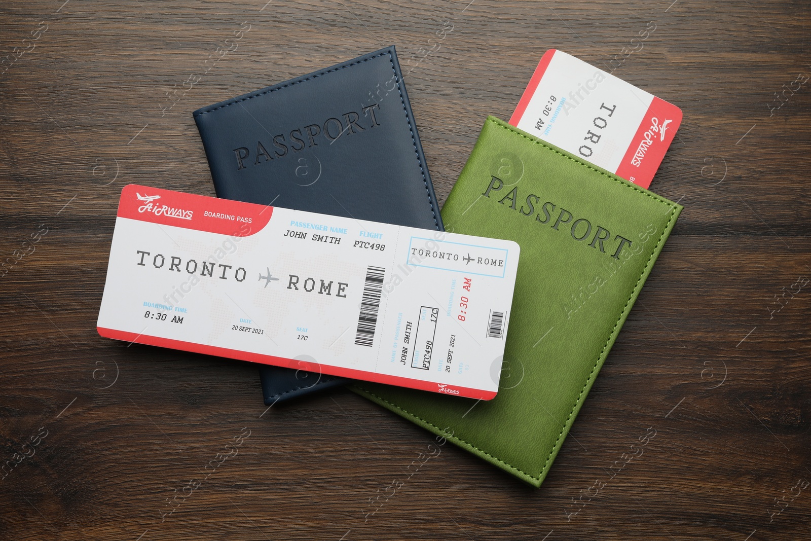 Photo of Travel agency. Flight tickets and passports on wooden table, flat lay