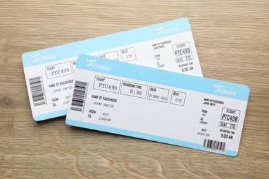 Photo of Travel agency. Flight tickets on wooden table, top view