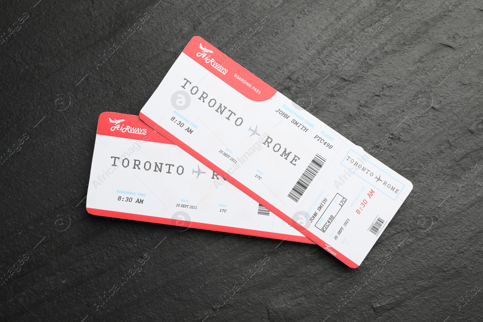 Photo of Travel agency. Flight tickets on dark textured table, top view