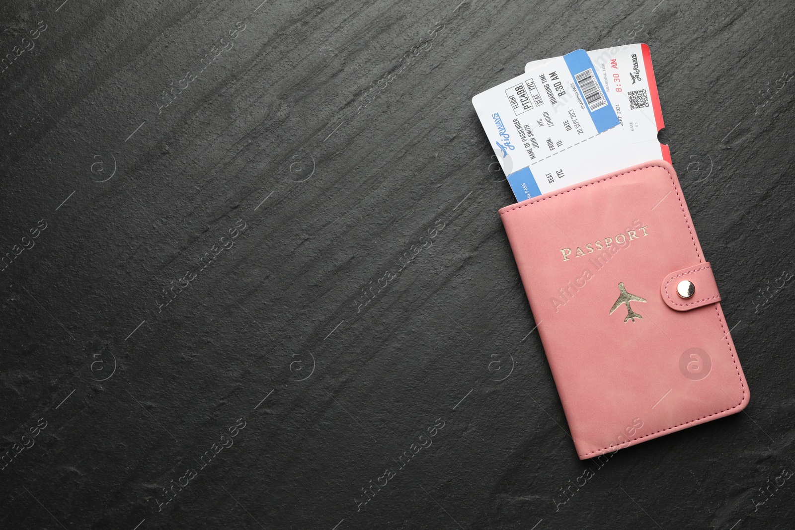 Photo of Travel agency. Flight tickets and passport on dark textured table, top view. Space for text