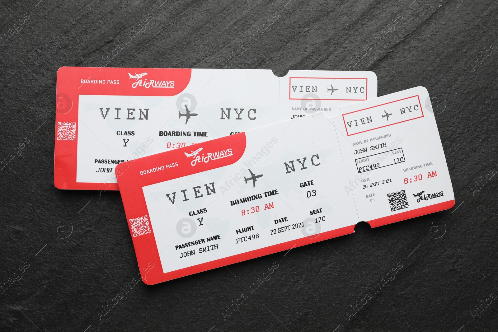 Photo of Travel agency. Flight tickets on dark textured table, top view