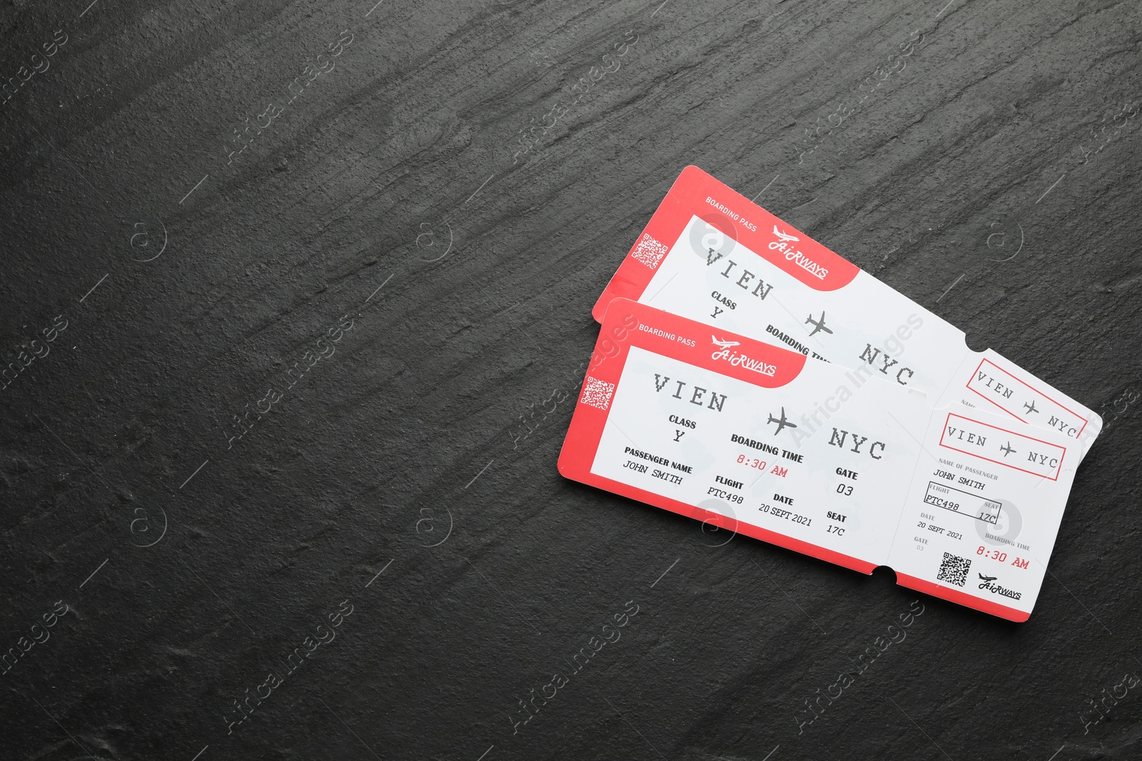 Photo of Travel agency. Flight tickets on dark textured table, top view. Space for text